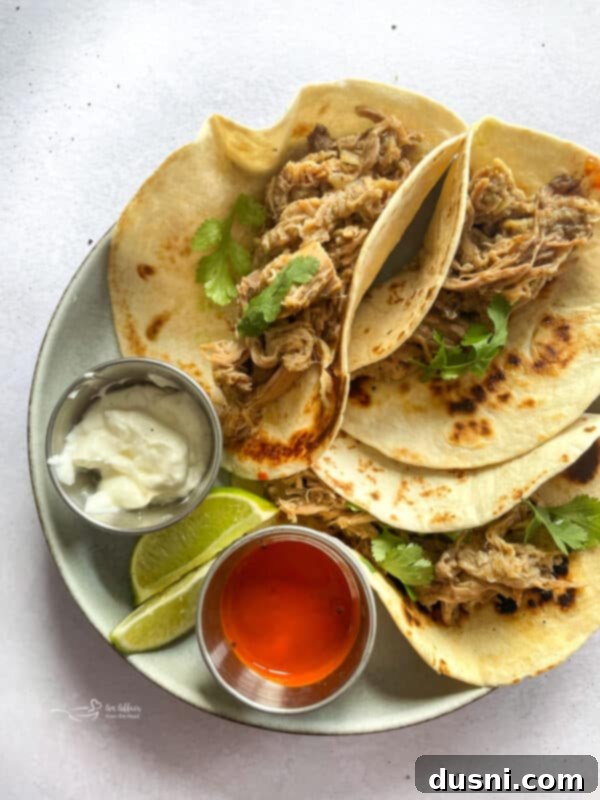Crispy Tender Slow Cooker Carnitas 14 Shredded Slow Cooker Carnitas in liquid