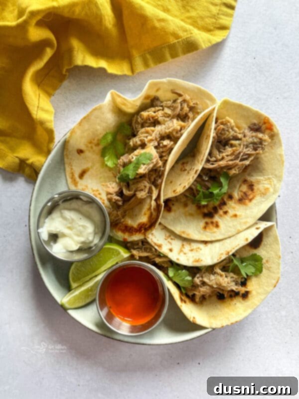 Crispy Tender Slow Cooker Carnitas 5 Slow Cooker Carnitas in tacos with fresh toppings