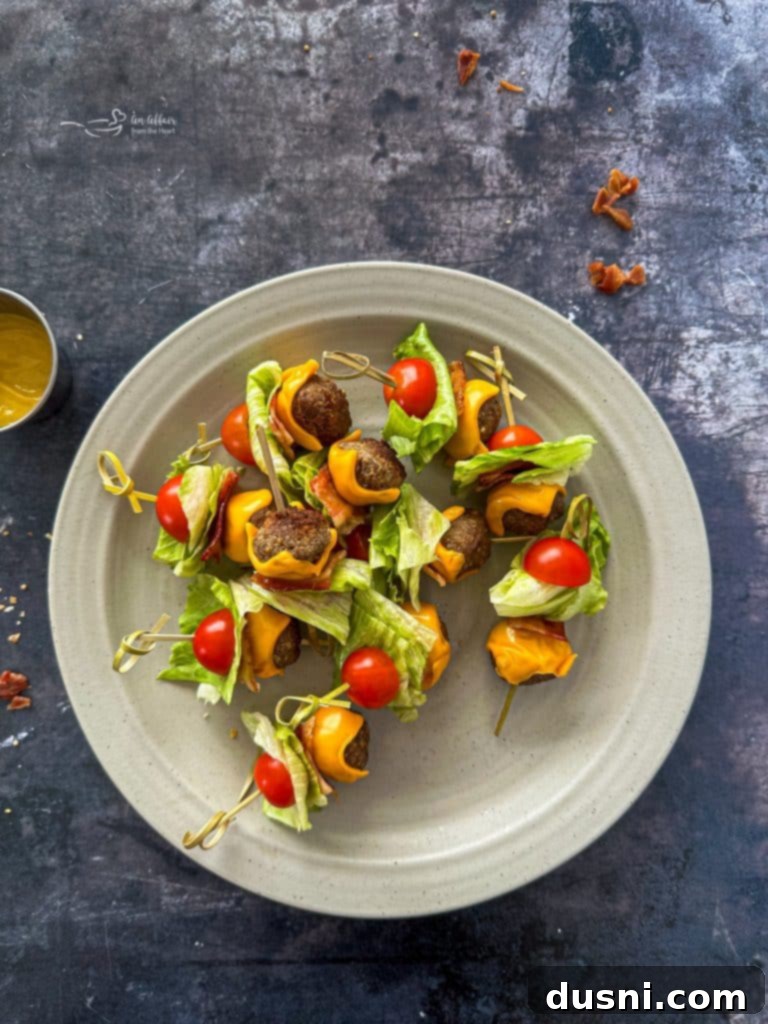 Bacon Cheeseburger Meatballs plated with a side of dipping sauces