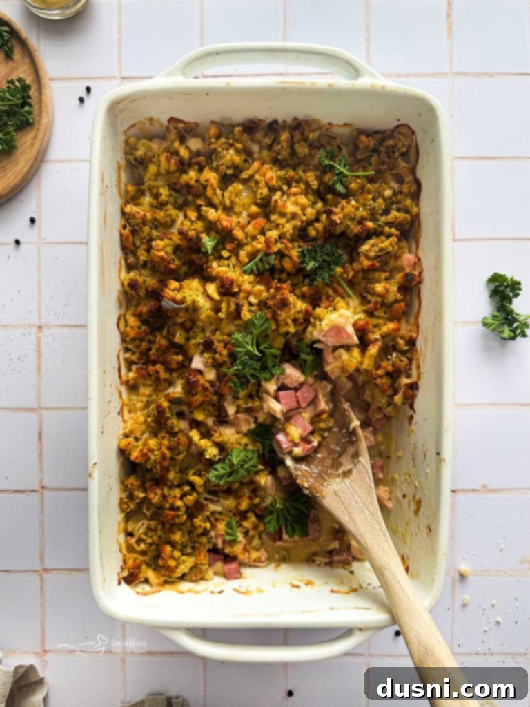 Creamy Chicken Cordon Bleu Bake 2 A delicious Chicken Cordon Bleu Casserole fresh from the oven, with a golden-brown stuffing topping and melted Swiss cheese peeking through.