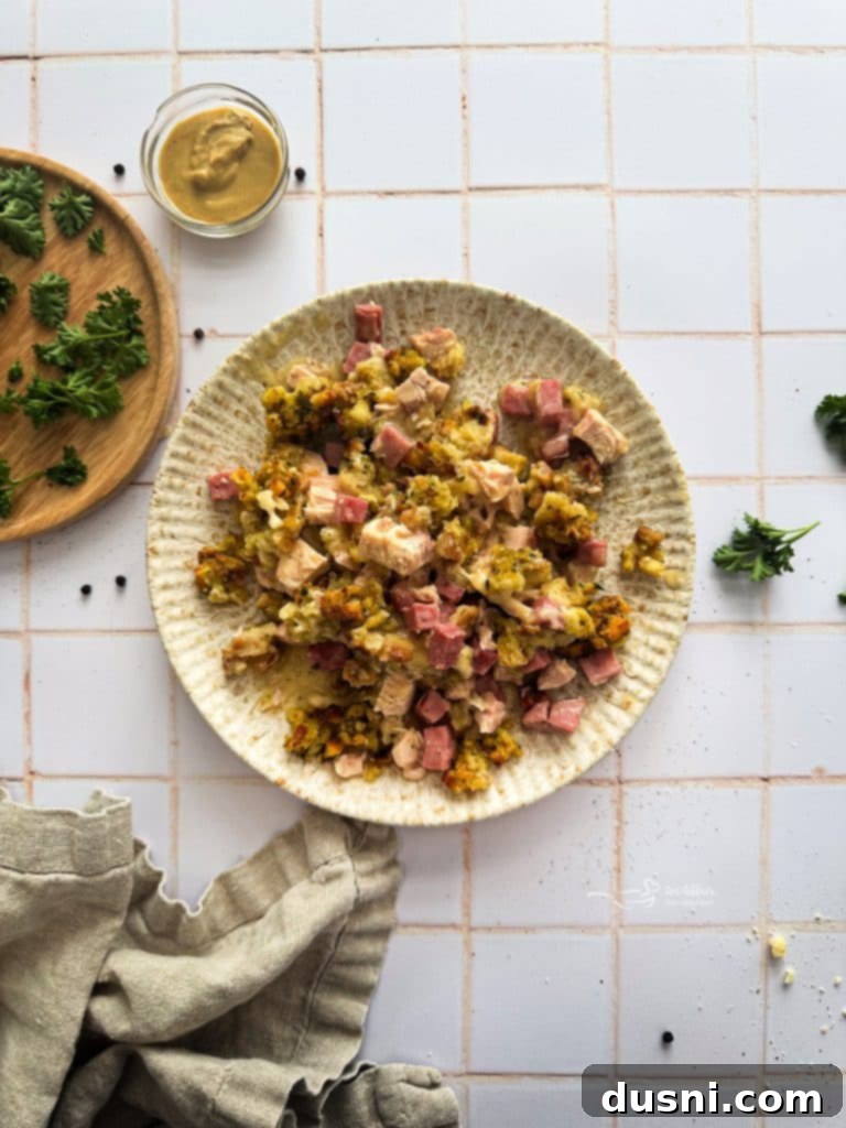 Creamy Chicken Cordon Bleu Bake 3 A close-up shot of the Chicken Cordon Bleu Casserole, showcasing the layers of chicken, ham, and melted cheese, with the golden stuffing topping.