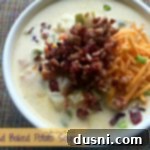 Close up of a warm bowl of Loaded Baked Potato Soup, ready to be served.