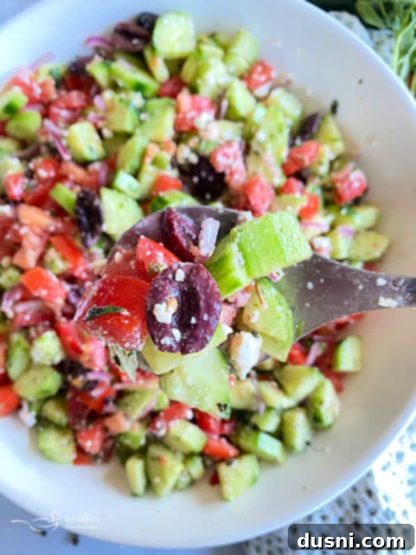 Hellenic Cucumber Medley 12 Delicious Greek Cucumber Salad in a white bowl, ready for serving.
