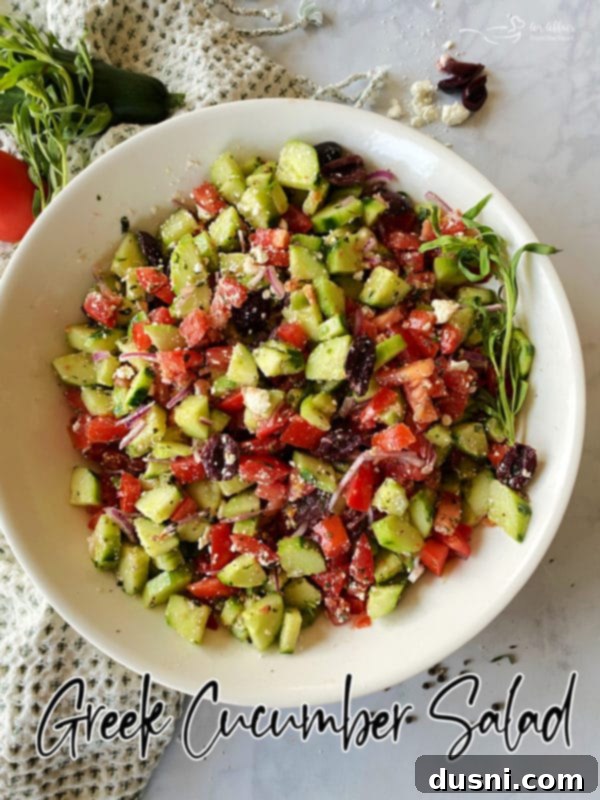 Hellenic Cucumber Medley 13 Greek cucumber salad elegantly presented in a white bowl, highlighting its fresh ingredients and inviting textures.