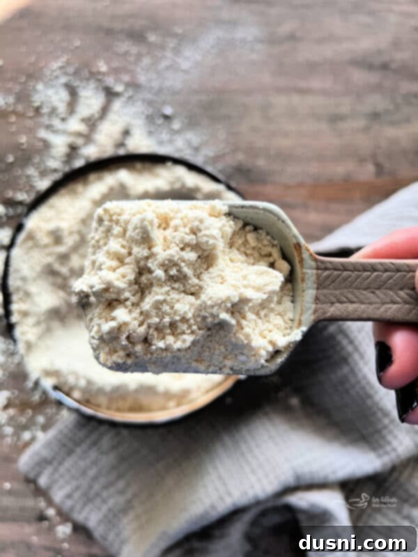 Better Bisquick From Your Kitchen 11 A scoop of homemade Bisquick mix on a measuring spoon