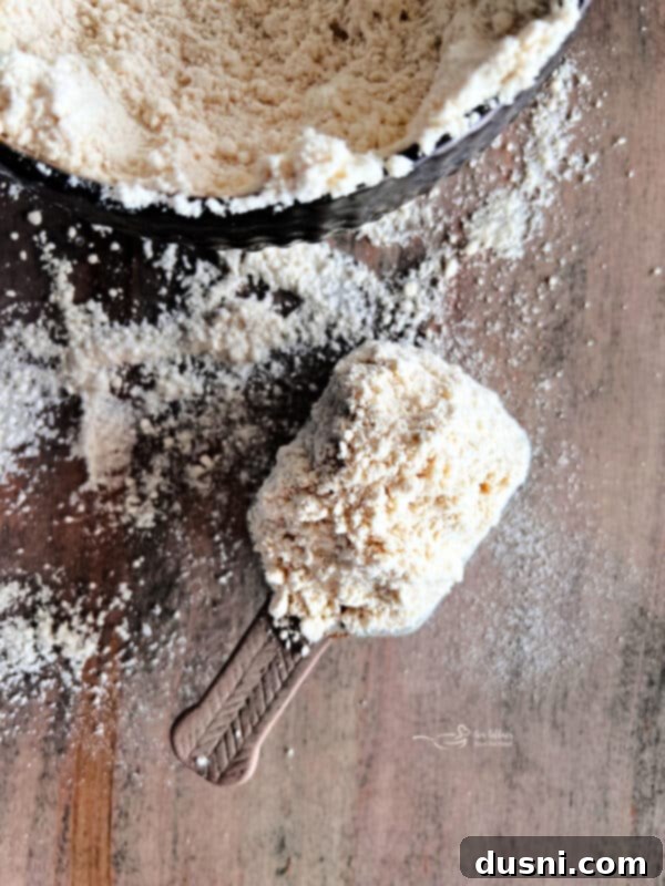 Better Bisquick From Your Kitchen 4 A hand adding shortening to flour in a mixing bowl for homemade Bisquick