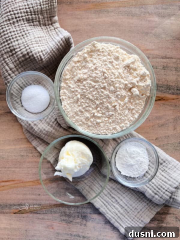 Better Bisquick From Your Kitchen 5 Individual ingredients for homemade Bisquick mix laid out on a kitchen counter