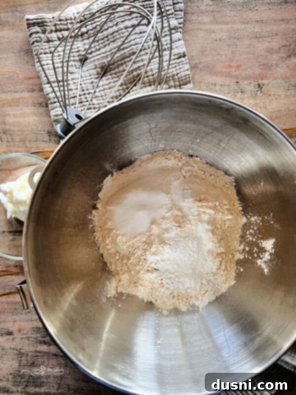 Better Bisquick From Your Kitchen 7 Dry ingredients for homemade Bisquick mix being whisked in a stand mixer