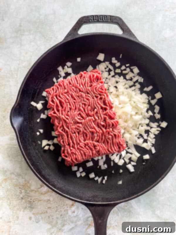 Ground beef and onion browning in a skillet