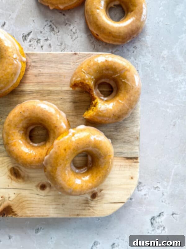 Moist Baked Pumpkin Donuts with Spiced Glaze, perfect for fall breakfasts