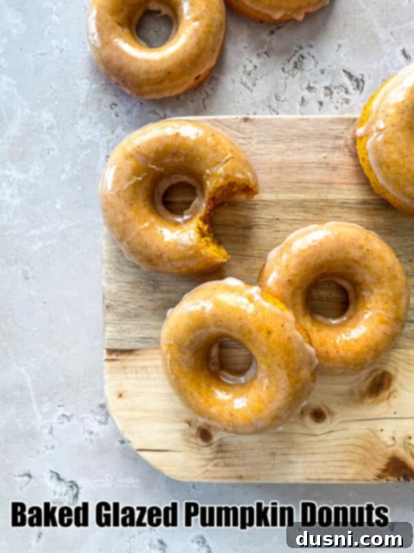 A beautifully arranged serving of Glazed Baked Pumpkin Donuts, ready to be enjoyed.