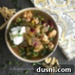 Overhead view of Five Bean Chicken Chili in a white bowl, ready to be served.
