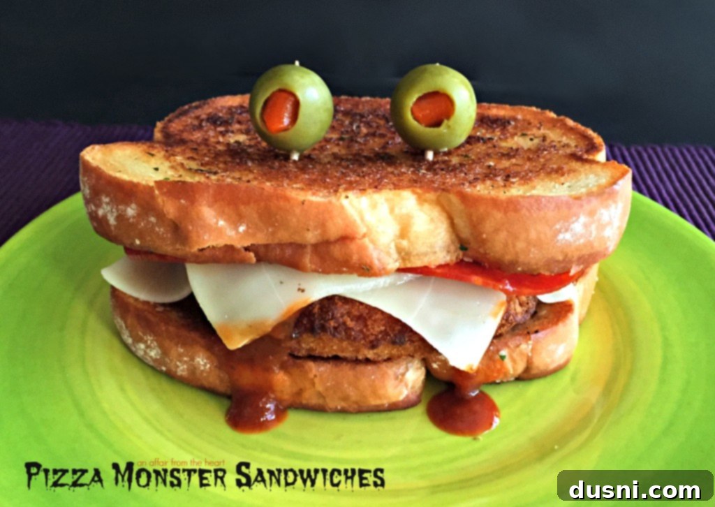 Two Pizza Monster Sandwiches on a green plate, ready to be devoured