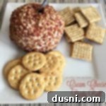 Close up of Cream Cheese Party Ball and crackers on a white plate