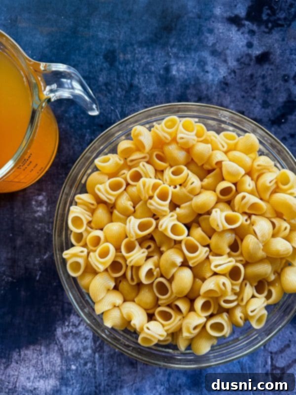Overhead view of a bowl of chicken parmesan soup with a spoon