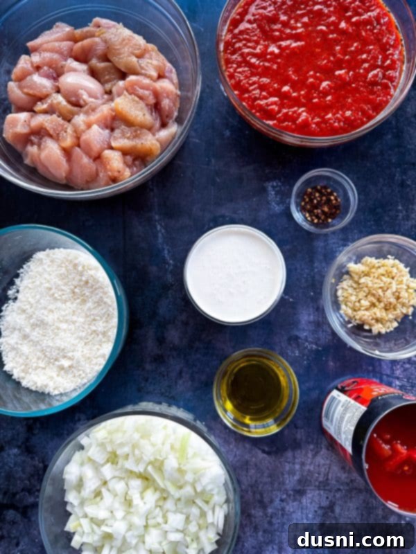 A large pot of creamy chicken parmesan soup on a stovetop