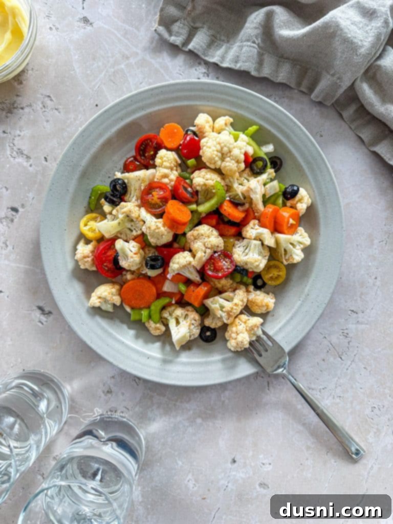 Zesty Marinated Veggies 4 A large glass bowl filled with colorful chopped vegetables, ready for marinating.