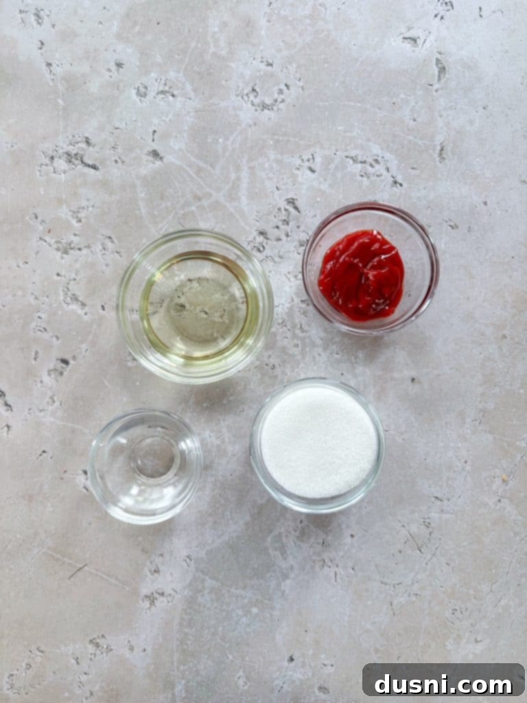 Zesty Marinated Veggies 6 Ingredients for the sweet marinade: sugar, oil, ketchup, and white vinegar in separate bowls.