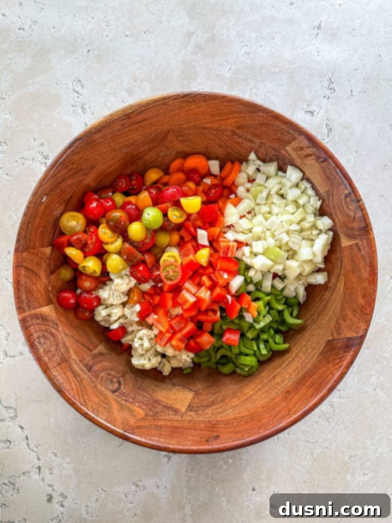Zesty Marinated Veggies 7 Hands chopping fresh vegetables on a cutting board, preparing them for the marinated salad.
