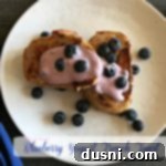 overhead of french toast on a white plate with text 'Blueberry Yogurt French Toast