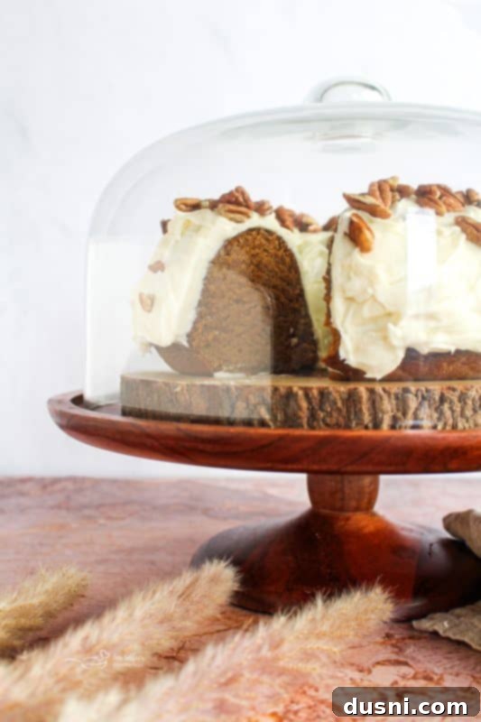 Close-up of frosted Pumpkin Bundt Cake with pecans