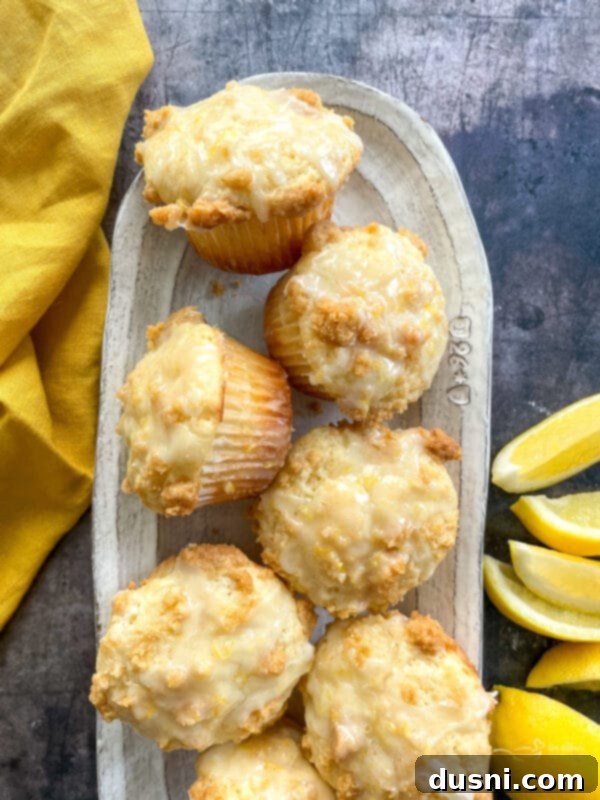 Fluffy and moist bakery-style lemon muffins with a wonderful streusel crumb topping, baked golden brown and glazed with a sweet-tart lemon glaze. You will want to make these muffins again and again!