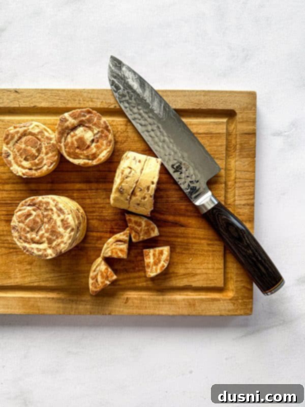 Pillsbury Cinnamon Rolls dough cut into quarters on a cutting board