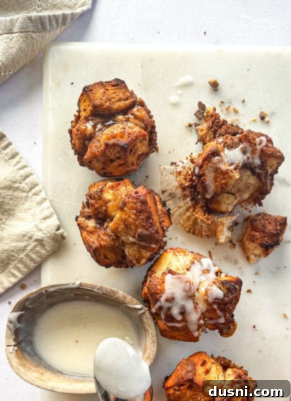 Freshly baked Toffee Monkey Bread Muffins in a muffin tin, cooling