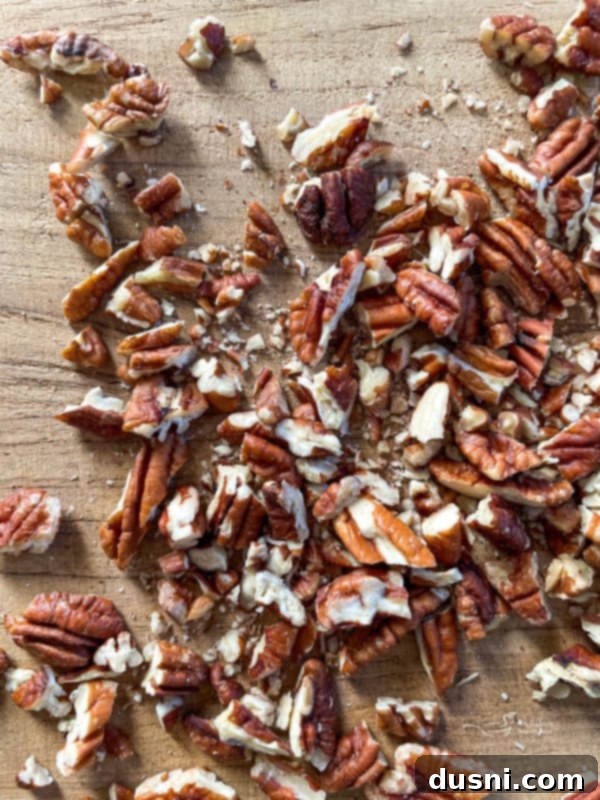 Graham Cracker Toffee chopped pecans on wooden surface