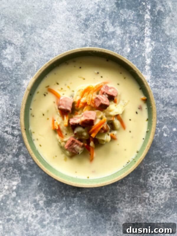 Indulgent Cream of Reuben Soup 13 Creamy Reuben soup in a bowl with a spoon