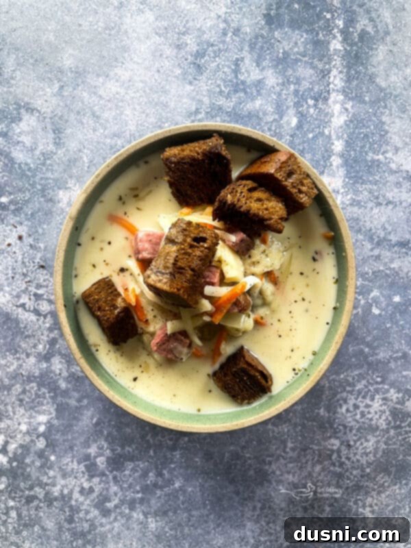 Indulgent Cream of Reuben Soup 14 A large pot of creamy Reuben soup on a stovetop