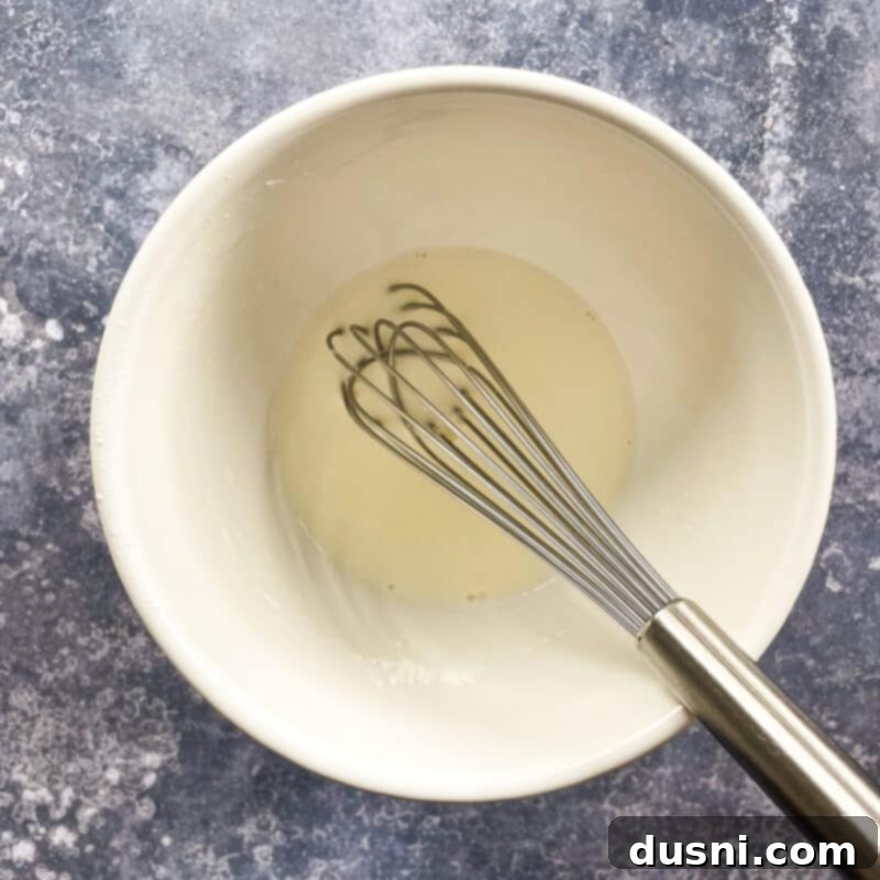 Indulgent Cream of Reuben Soup 7 Close-up of removing bay leaf from simmering Reuben soup