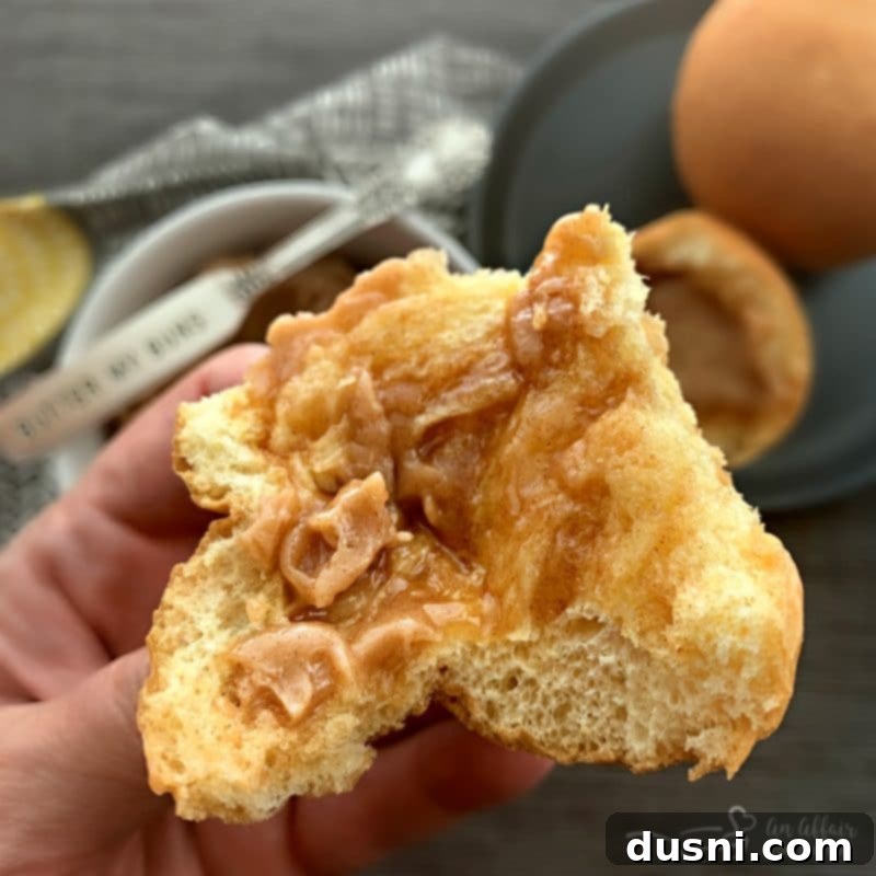 Warm dinner roll with melted cinnamon honey butter
