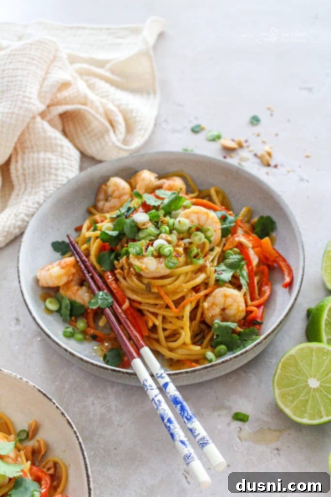 A vibrant bowl of One-Pot Pad Thai Wonderpot with shrimp and vegetables, ready to be enjoyed.