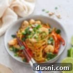 Pad Thai Wonderpot in a bowl with chops sticks leaning on the bowl.