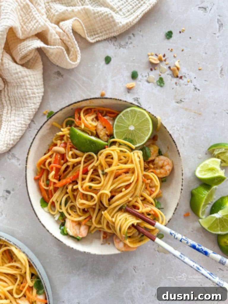 Close-up of fresh ingredients for Pad Thai, including colorful vegetables and noodles.