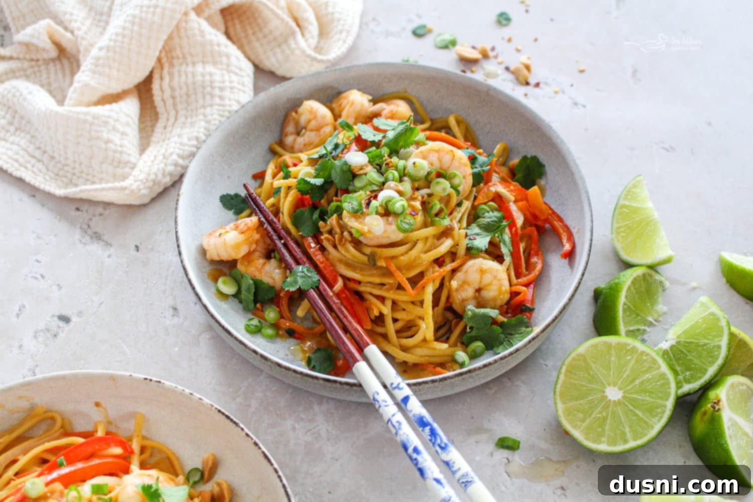 A close-up shot of a bowl of One-Pot Pad Thai, garnished with fresh cilantro and crushed peanuts.