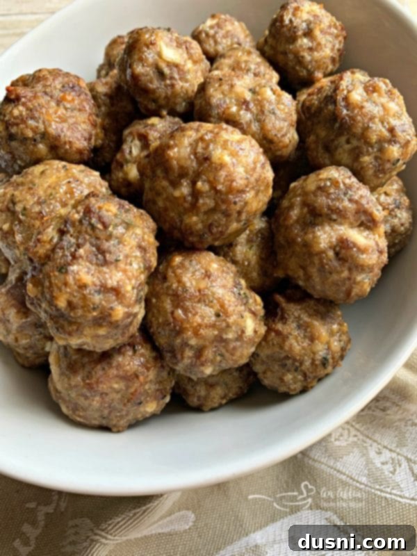 Close up of classic Italian Meatballs in a white bowl with parsley garnish