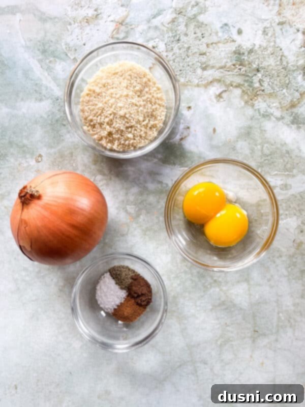 Ingredients for Swedish meatballs laid out on a cutting board, including ground meat, breadcrumbs, and spices