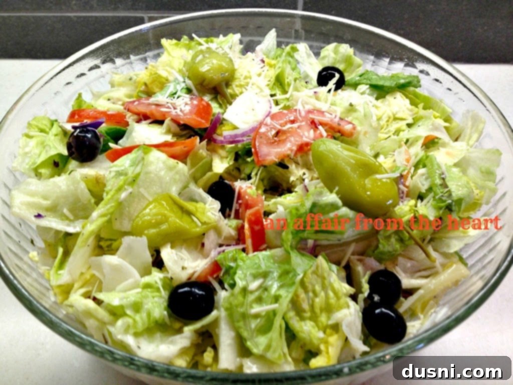 Olive Garden Salad - Crisp lettuce, tomatoes, olives, croutons, and signature dressing.