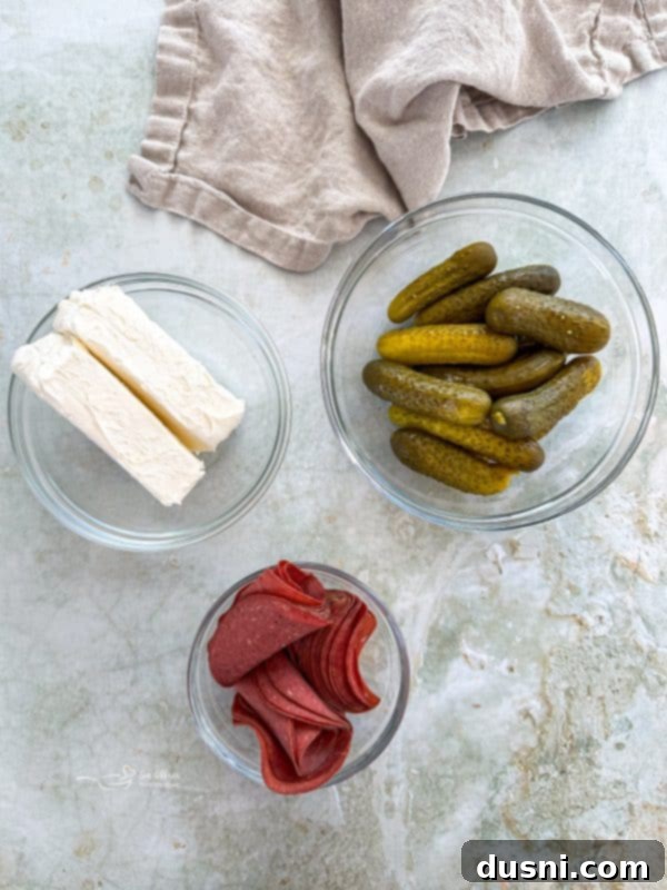 Zesty Dill Pickle Dip 6 A bowl of creamy Dill Pickle Dip with a spoon resting in it