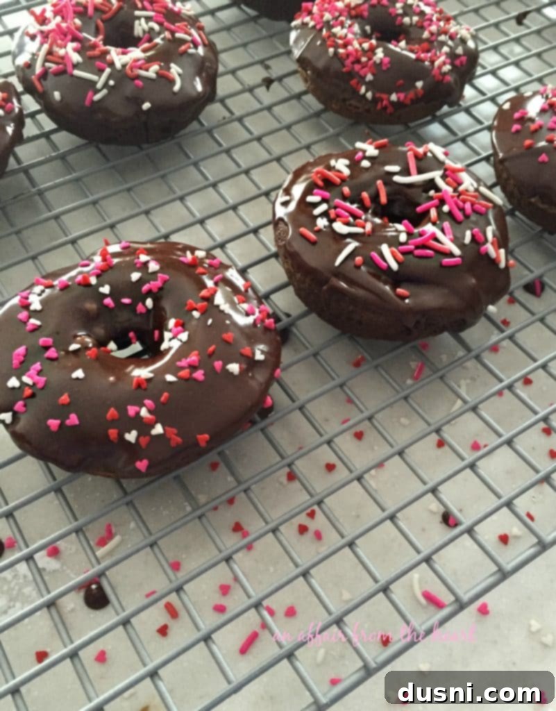 Lush Double Chocolate Baked Donuts being glazed on a baking rack