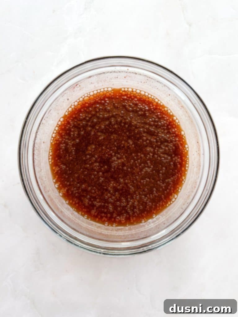 Tender cooked ribs being transferred to a wire rack