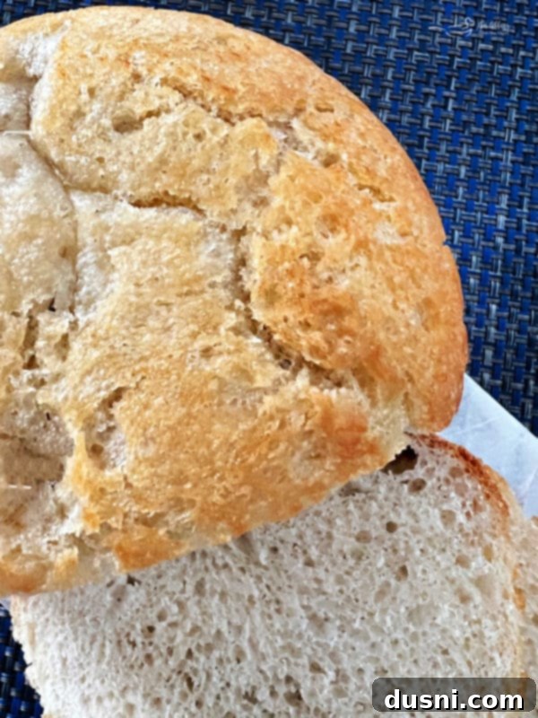 Peasant Bread Recipe Overhead shot of a rustic peasant bread loaf, with a beautifully browned crust and irregular shape.