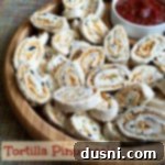 Tortilla Pinwheels on a wooden serving tray with text "tortilla pinwheels"