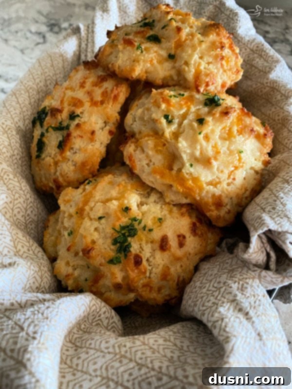 Top view of Cheddar Bay biscuits in basket with linen