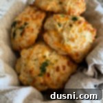 Five cheddar bay biscuits in basket