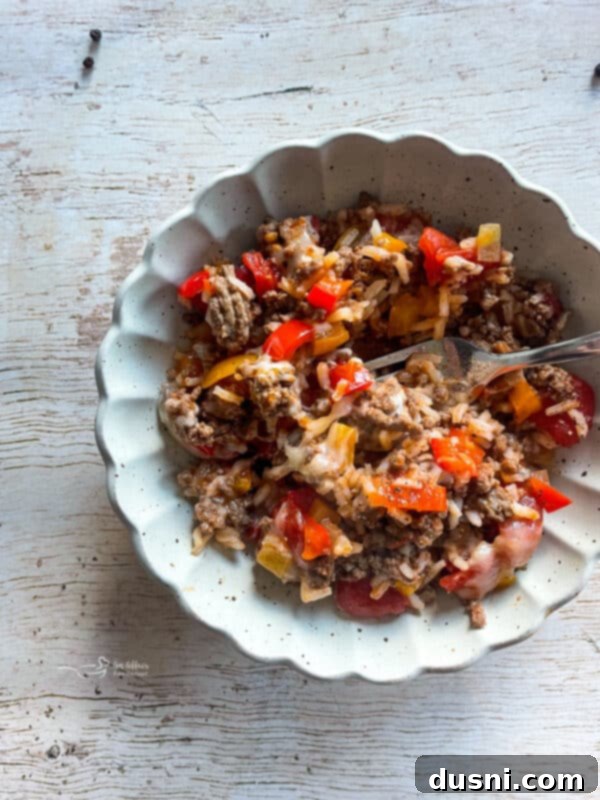 One-Pan Stuffed Peppers 13 Stuffed Pepper Skillet in a skillet with a serving spoon