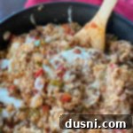 One-Pan Stuffed Peppers 18 Stirring the cheese into Stuffed pepper skillet