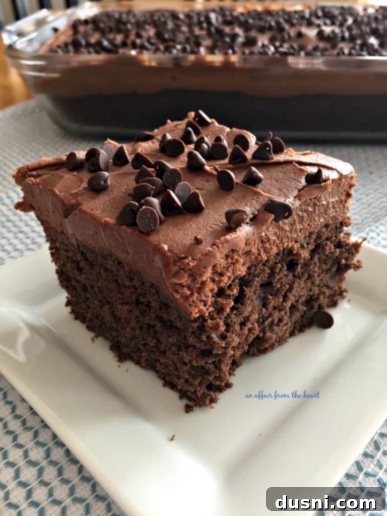 A slice of homemade Chocolate Banana Cake with thick sour cream frosting